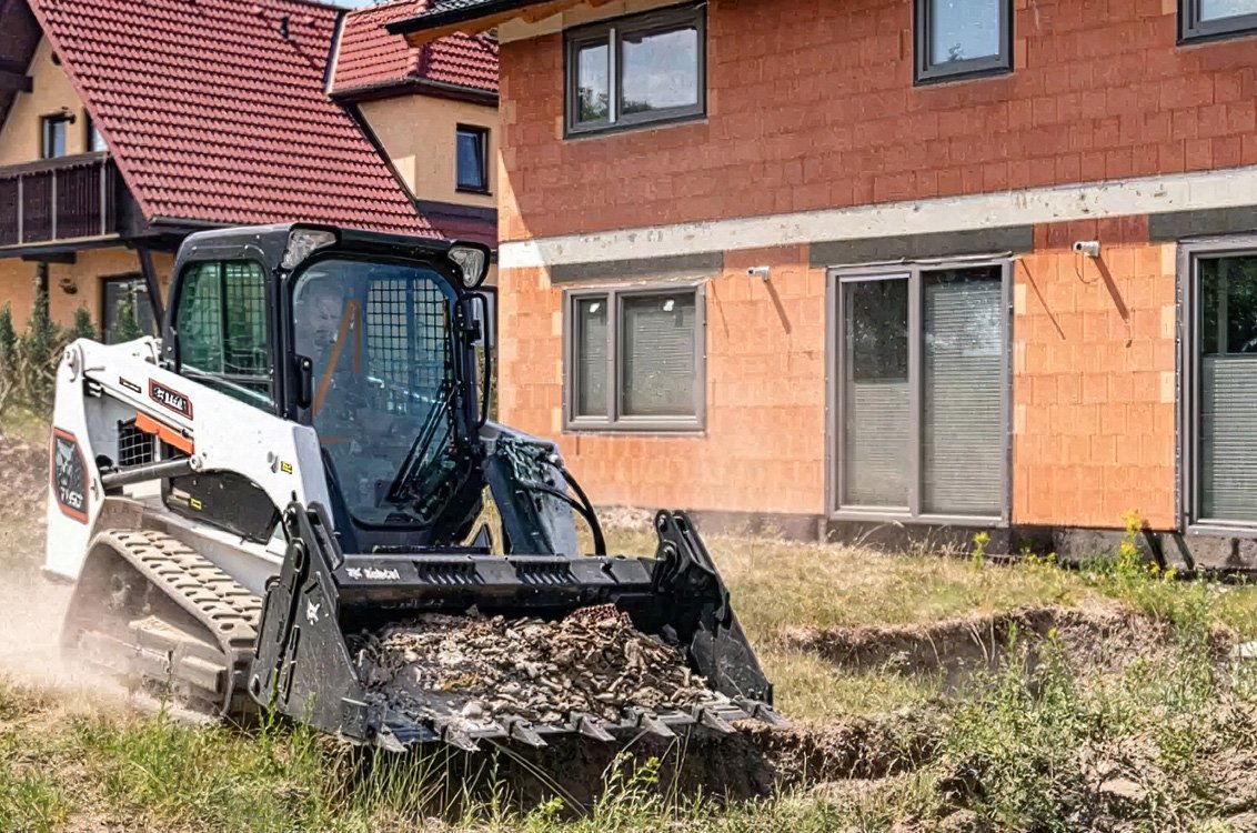 Bobcat T450 Compact Track Loader hauling dirt debris