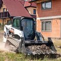 Bobcat T450 Compact Track Loader hauling dirt debris