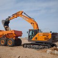 DEVELON DX230LC-9 Crawler Excavator discharging in a DEVELON articulated dump truck