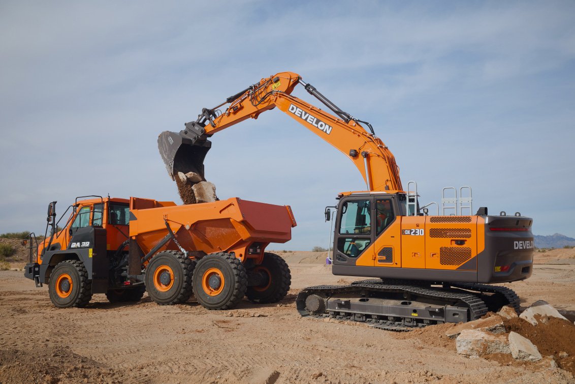 DEVELON DX230LC-9 Crawler Excavator discharging in a DEVELON articulated dump truck