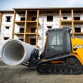 JCB 400T Compact Track Loader carrying heavy cement pipe