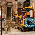 JCB 19C-1E Electric Mini Excavator breaking rocks in a confined space