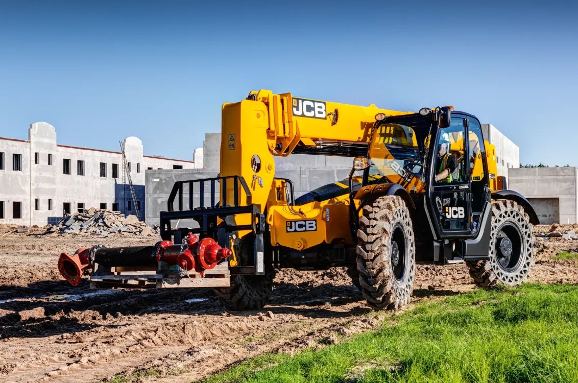 JCB 509-42 Telehandler hauling a heavy fire hydrant system