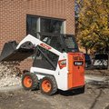 Bobcat S70 Skid Steer Loader dumping landscape rock