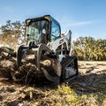 Bobcat T650 Compact Track Loader with a root grapple