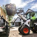 Bobcat L35 Small Articulated Loader dumping debris with a root grappler attachment