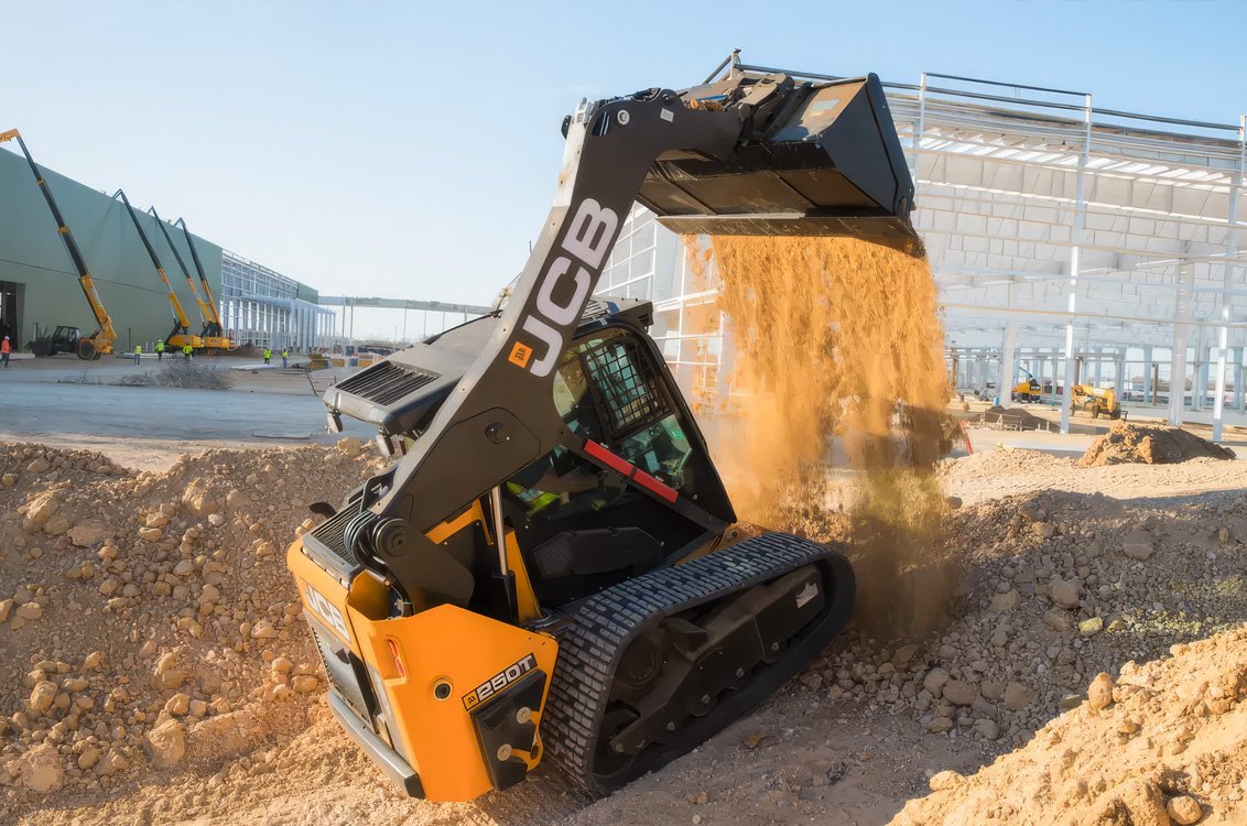 JCB 250T Compact Track Loader dumping construction dirt