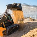 JCB 250T Compact Track Loader dumping construction dirt