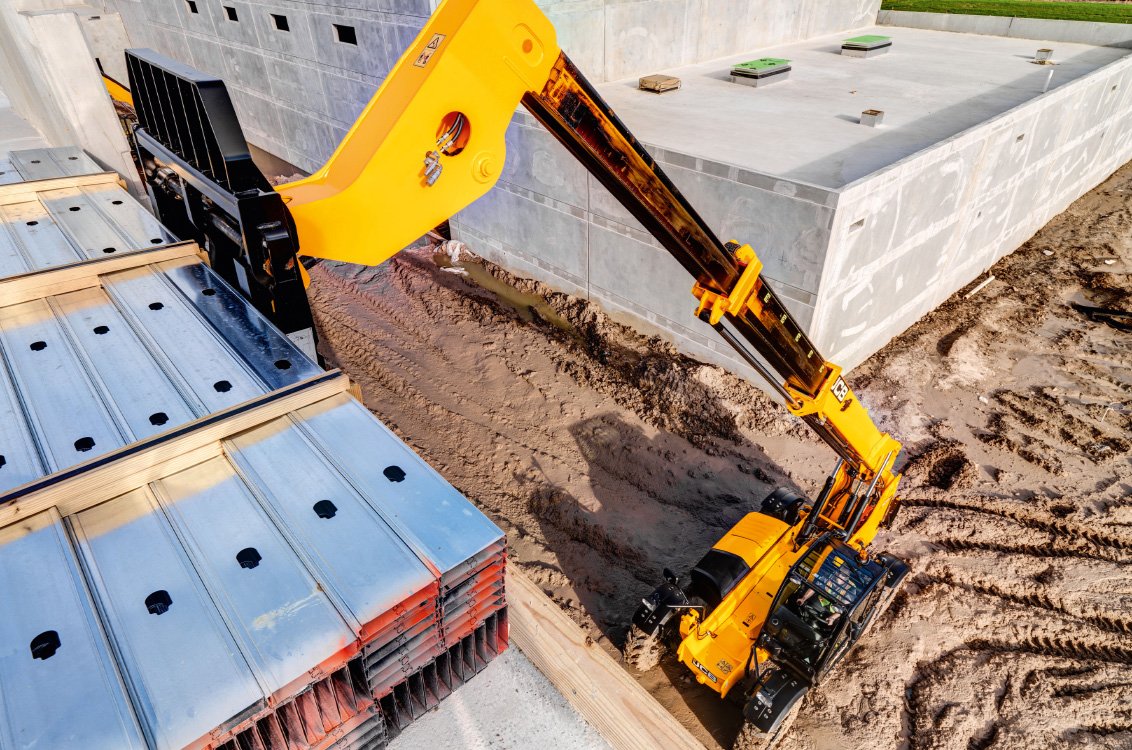 JCB 510-56 Telehandler stacking heavy material in a high location