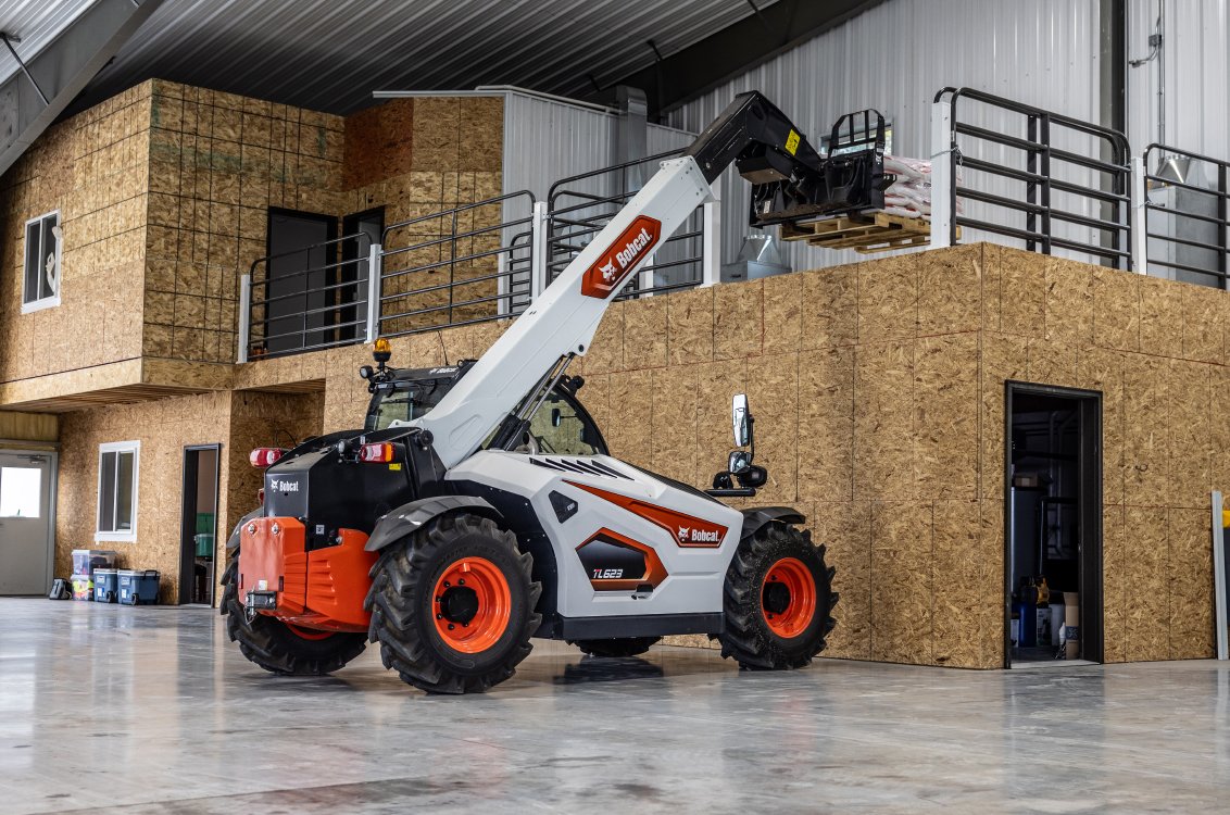 Bobcat TL623 Telehandler loading a pallet of fertilizer into a high loft