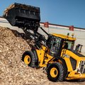 JCB 427 Wheel Loader movings wood scrap