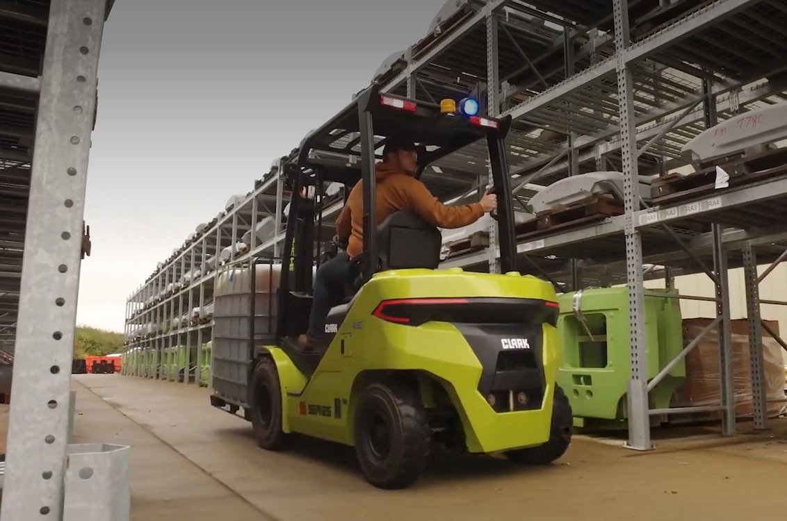 Clark S30XE Renegade Electric Rider Pneumatic Forklift working in outdoor warehouse