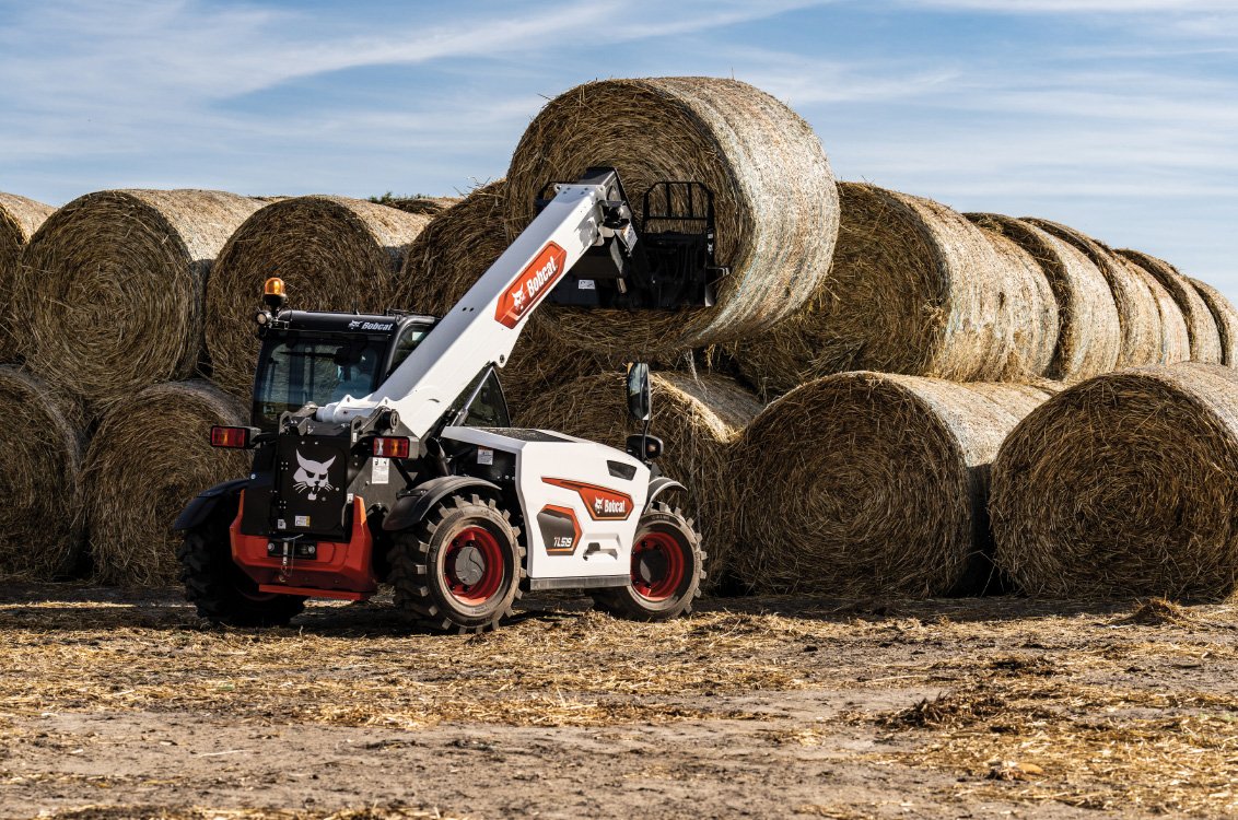 Bobcat TL519 Telehandler stacking large rolls of hay