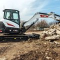 Bobcat E48 Mini Excavator moving scrap cement