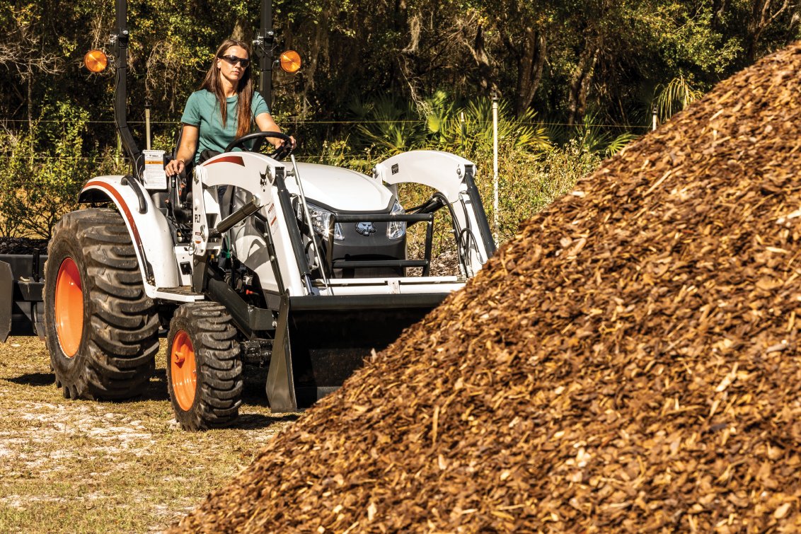 Bobcat CT2025 HST Compact Tractor hauling wood mulch