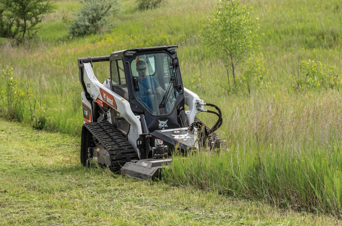 Bobcat T76 Compact Track Loader cutting field grass