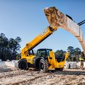 JCB 510-56 Telehandler lifting heavy load on construction site