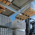 Linde E50/600HL Heavy-Duty Electric Pneumatic Forklift lifting a large heavy tank
