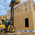 JCB 950 Rough Terrain Forklift lifting wood framing material