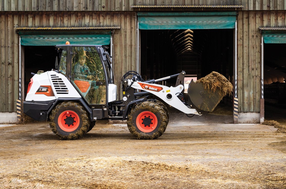 Bobcat L95 Articulated Loader mucking a barn