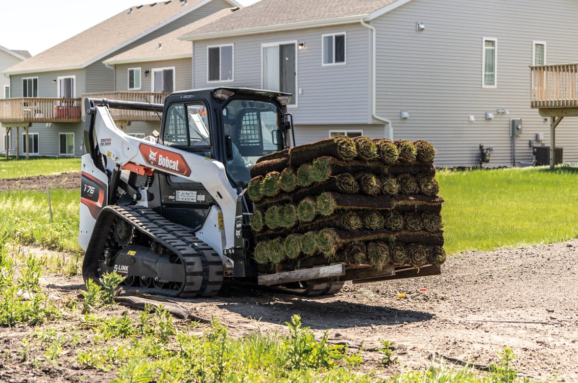 Bobcat T76 Compact Track Loader hauling sod grass