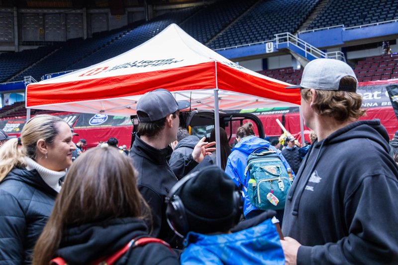 The Williams Machinery booth is packed with interested attendees at the Monster Jam Pit Party, Vancouver 2024