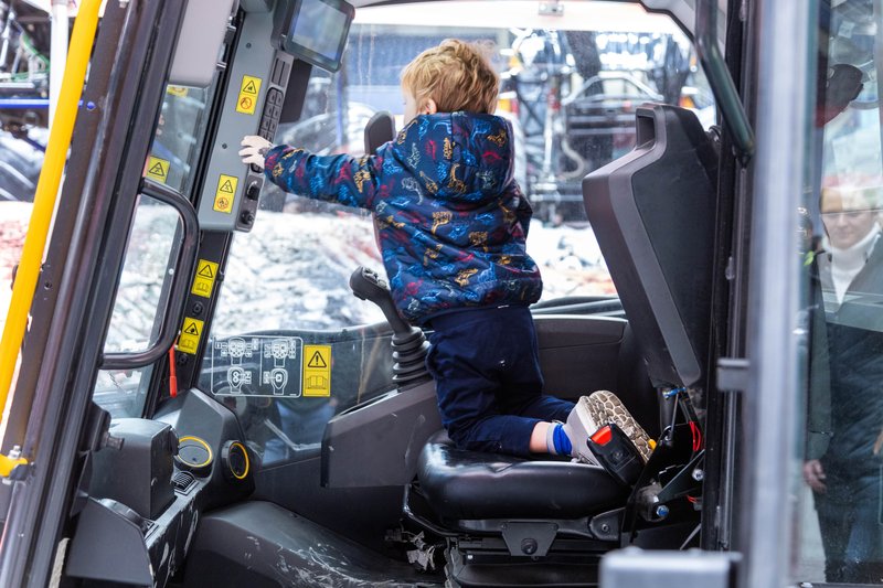 Kids play in a JCB teleskid cab at the Monster Jam Vancouver show
